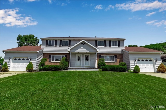 6192 Thornwood Dr, Boston, NY 14075 - view of front facade with an attached garage, brick siding, a front lawn, and driveway