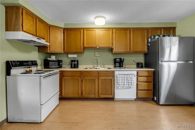 6192 Thornwood Dr, Boston, NY 14075 - kitchen with white appliances, under cabinet range hood, light countertops, and light wood-style floors