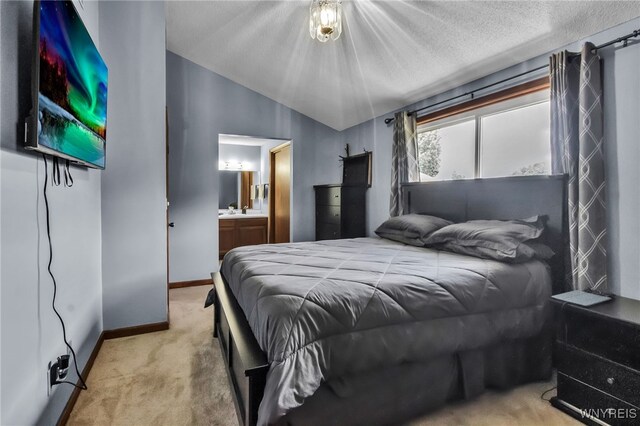 6192 Thornwood Dr, Boston, NY 14075 - carpeted bedroom featuring vaulted ceiling, ensuite bathroom, and a textured ceiling