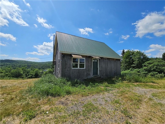 2857 County Route 84, Troupsburg, NY 14885 - view of home's exterior with a metal roof and entry steps