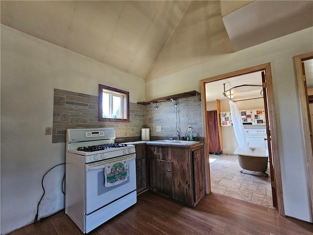 2857 County Route 84, Troupsburg, NY 14885 - kitchen featuring gas range gas stove, lofted ceiling, and dark wood finished floors