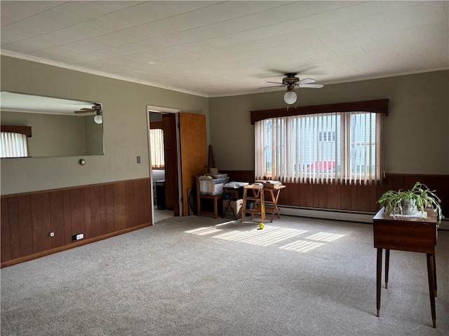 21 Main St, Maryland, NY 12155 - carpeted living area featuring a ceiling fan, a wainscoted wall, wood walls, a baseboard heating unit, and ornamental molding