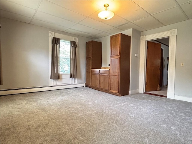 21 Main St, Maryland, NY 12155 - unfurnished living room with a baseboard heating unit, a drop ceiling, and light carpet