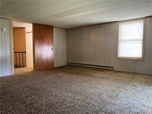 21 Main St, Maryland, NY 12155 - empty room featuring baseboard heating, carpet flooring, and wood walls
