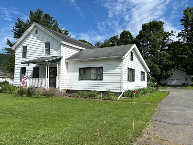 21 Main St, Maryland, NY 12155 - traditional-style home with a porch, a front lawn, an outbuilding, roof with shingles, and a detached garage