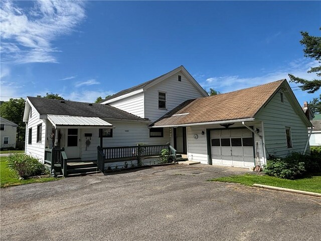 21 Main St, Maryland, NY 12155 - view of front of property featuring asphalt driveway, an attached garage, and a shingled roof