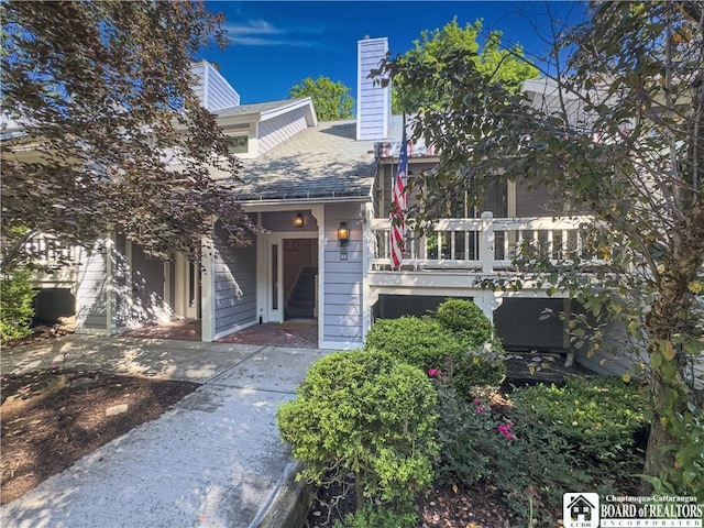20 Elm Ln Unit E5, Chautauqua, NY 14722 - view of front facade featuring a balcony, a chimney, and roof with shingles