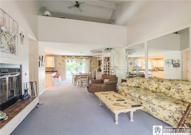 20 Elm Ln Unit E5, Chautauqua, NY 14722 - carpeted living room with high vaulted ceiling, a glass covered fireplace, and a ceiling fan