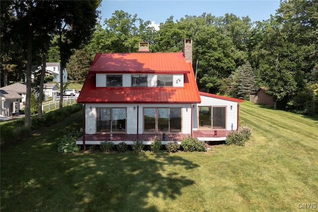 2761 E Lake Rd, Skaneateles, NY 13152 - rear view of house with a chimney, a metal roof, and a wooden deck