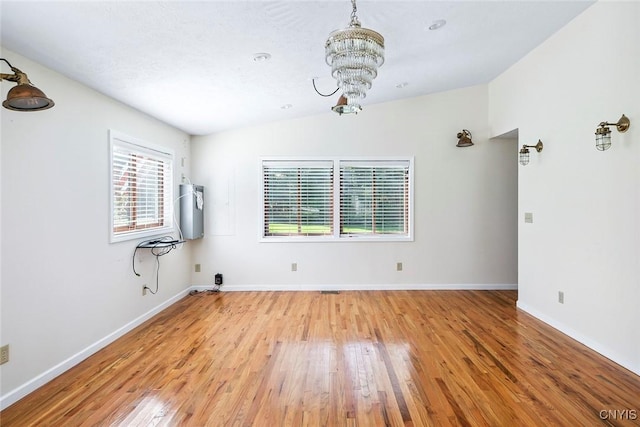 2761 E Lake Rd, Skaneateles, NY 13152 - empty room featuring a chandelier, light wood-style flooring, and lofted ceiling