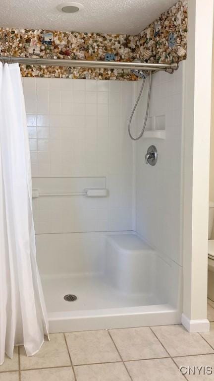 2761 E Lake Rd, Skaneateles, NY 13152 - bathroom with tile patterned flooring, a shower stall, and a textured ceiling