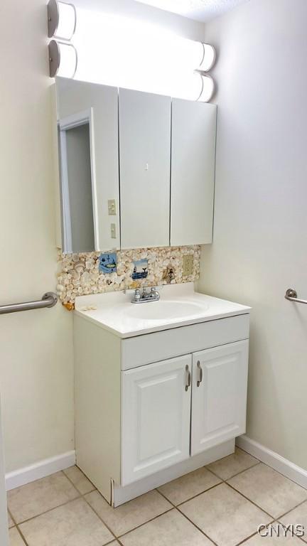 2761 E Lake Rd, Skaneateles, NY 13152 - bathroom featuring tile patterned flooring, vanity, and backsplash