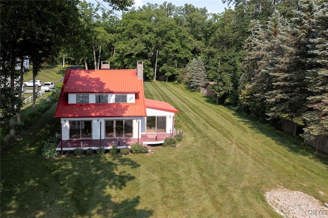 2761 E Lake Rd, Skaneateles, NY 13152 - rear view of house featuring a chimney, a wooden deck, and a metal roof