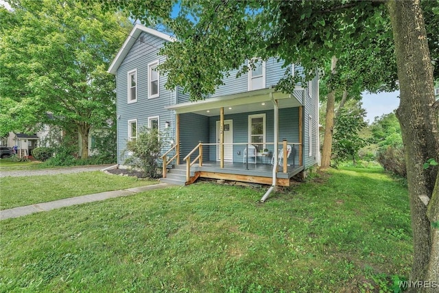 12 Clark St, Perry, NY 14530 - view of front facade featuring covered porch and a front lawn