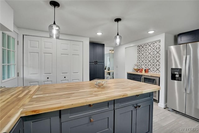 12 Clark St, Perry, NY 14530 - kitchen featuring stainless steel fridge with ice dispenser, butcher block counters, wine cooler, recessed lighting, and hanging light fixtures