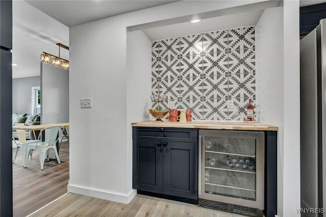 12 Clark St, Perry, NY 14530 - indoor dry bar with wine cooler, light wood-style flooring, recessed lighting, and hanging light fixtures