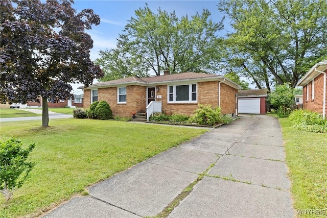 73 Willowcrest Dr, West Seneca, NY 14224 - view of front of property featuring brick siding, a front lawn, an outbuilding, a chimney, and driveway