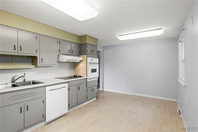 73 Willowcrest Dr, West Seneca, NY 14224 - kitchen with white appliances, under cabinet range hood, a warming drawer, light wood-type flooring, and gray cabinetry