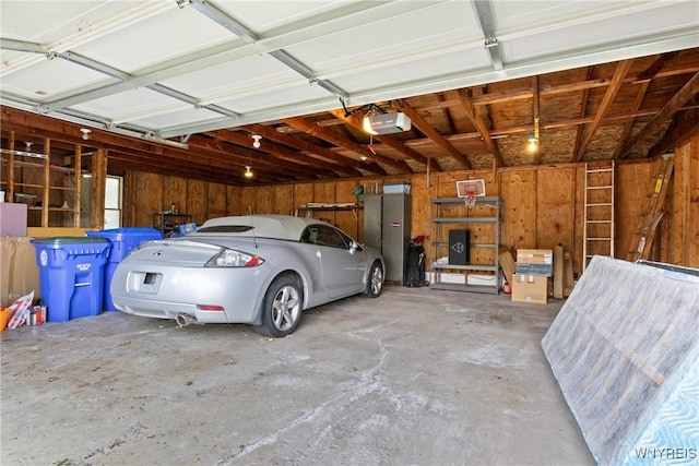 73 Willowcrest Dr, West Seneca, NY 14224 - garage with wooden walls and a garage door opener