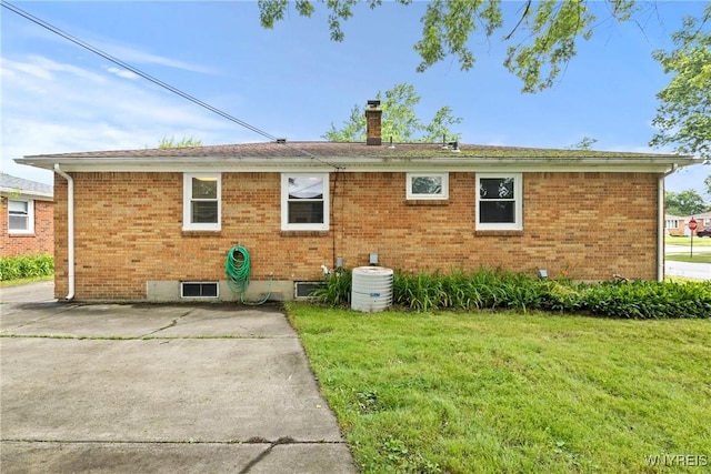 73 Willowcrest Dr, West Seneca, NY 14224 - back of property with a chimney, a lawn, and brick siding