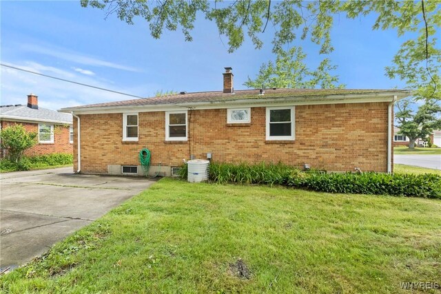 73 Willowcrest Dr, West Seneca, NY 14224 - back of house with brick siding, a yard, and a chimney