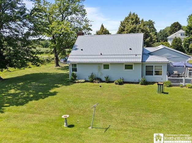5005 W Main Rd, Pomfret, NY 14063 - back of property with a yard, a metal roof, and a chimney