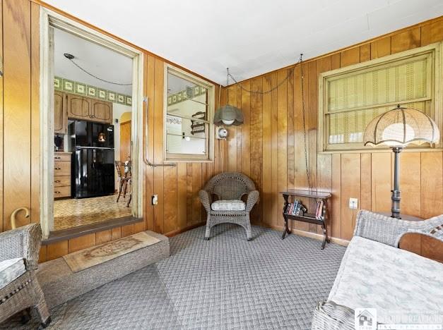 5005 W Main Rd, Pomfret, NY 14063 - living area featuring carpet and wood walls