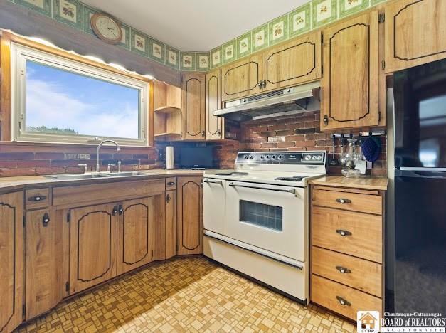5005 W Main Rd, Pomfret, NY 14063 - kitchen featuring electric stove, freestanding refrigerator, under cabinet range hood, backsplash, and light countertops