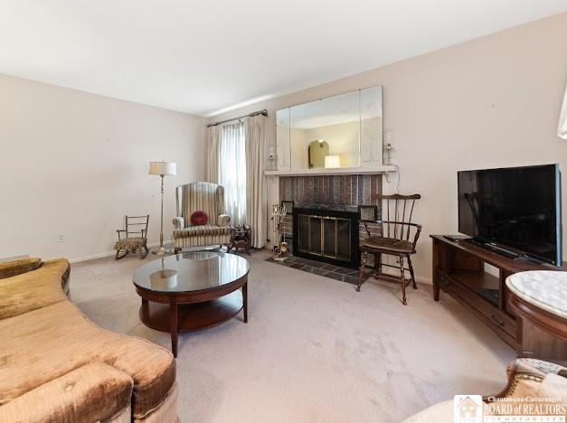 5005 W Main Rd, Pomfret, NY 14063 - living room with a brick fireplace and carpet flooring
