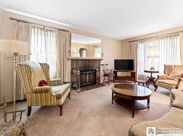 5005 W Main Rd, Pomfret, NY 14063 - carpeted living area featuring healthy amount of natural light and a brick fireplace