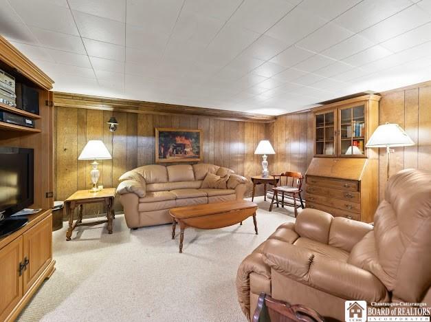 5005 W Main Rd, Pomfret, NY 14063 - living area with light colored carpet and wood walls