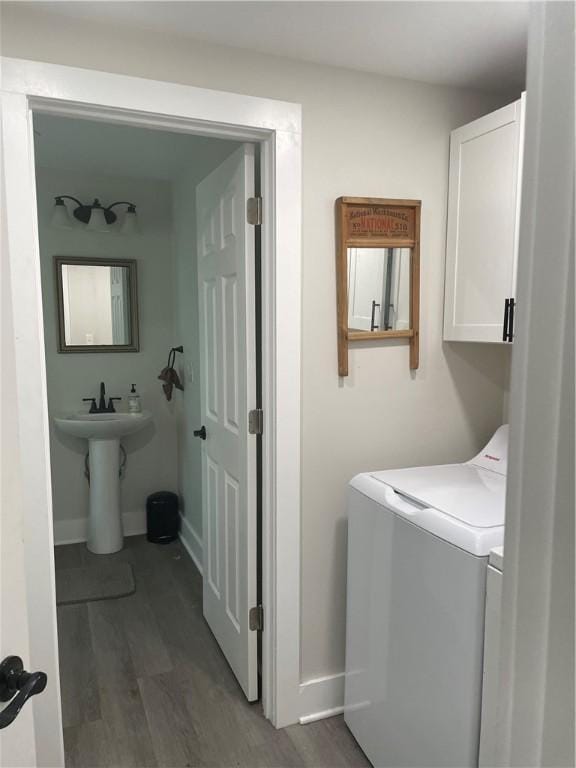 16562 Ridge Rd, Murray, NY 14470 - laundry area featuring dark wood-type flooring, cabinet space, and washer and clothes dryer