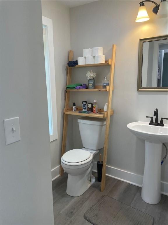 16562 Ridge Rd, Murray, NY 14470 - bathroom with wood finished floors and toilet