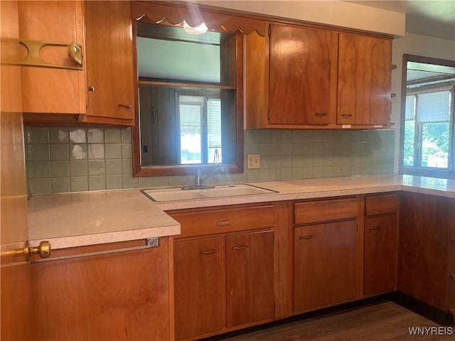 275 Nagel Dr, Cheektowaga, NY 14225 - kitchen featuring light countertops, brown cabinets, and decorative backsplash