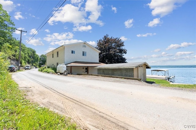 1659 Honoco Rd, Ledyard, NY 13026 - view of front facade with a water view, stucco siding, and dirt driveway