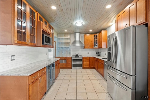 1659 Honoco Rd, Ledyard, NY 13026 - kitchen with appliances with stainless steel finishes, wall chimney range hood, beverage cooler, light tile patterned flooring, and brown cabinetry