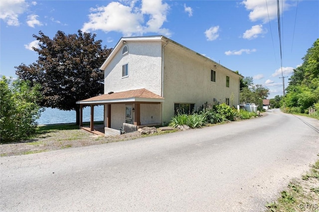 1659 Honoco Rd, Ledyard, NY 13026 - view of side of property featuring stucco siding and a water view