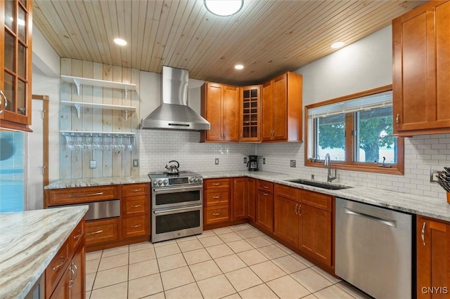 1659 Honoco Rd, Ledyard, NY 13026 - kitchen featuring appliances with stainless steel finishes, wall chimney range hood, brown cabinets, a warming drawer, and tasteful backsplash