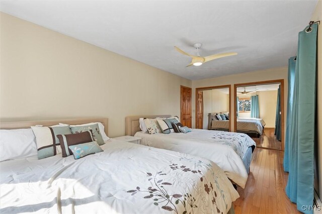 1659 Honoco Rd, Ledyard, NY 13026 - bedroom featuring light wood-type flooring, a ceiling fan, and two closets