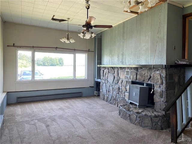 17106 State Route 3, Hounsfield, NY 13601 - unfurnished living room with carpet flooring, a baseboard radiator, a wood stove, ornamental molding, and wooden walls