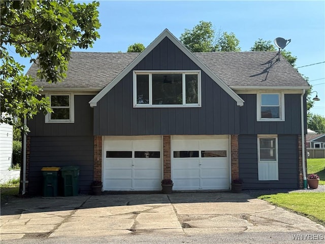 2656 Oakwood Ave, Hamburg, NY 14075 - modern inspired farmhouse with concrete driveway, an attached garage, roof with shingles, brick siding, and board and batten siding