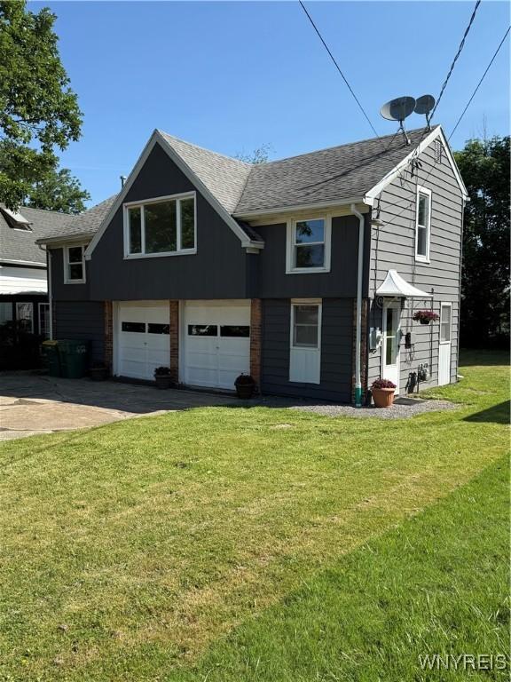 2656 Oakwood Ave, Hamburg, NY 14075 - view of front of home featuring an attached garage, roof with shingles, driveway, and a front lawn
