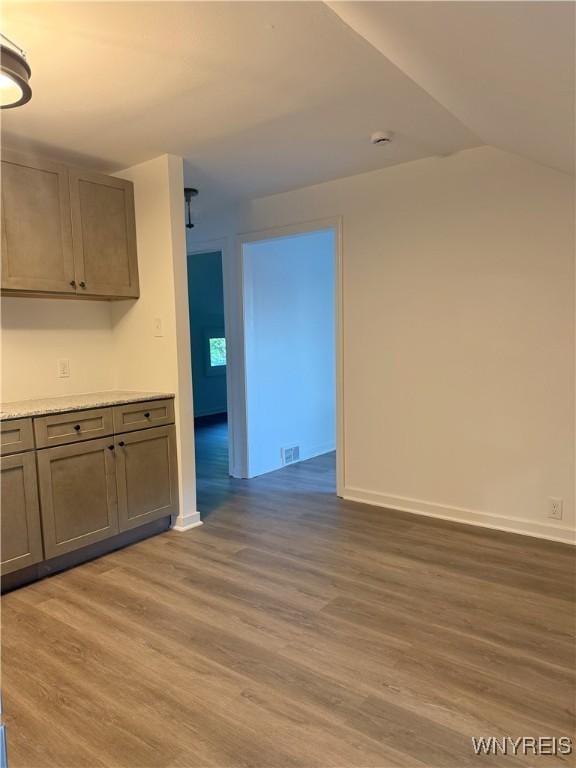 2656 Oakwood Ave, Hamburg, NY 14075 - empty room with light wood-type flooring, a smoke detector, and vaulted ceiling