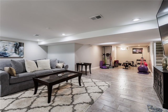 304 Simpson Rd, Irondequoit, NY 14617 - living room with wood finished floors, stairway, and recessed lighting