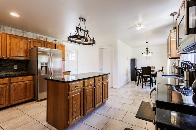 304 Simpson Rd, Irondequoit, NY 14617 - kitchen featuring stainless steel fridge, light tile patterned floors, brown cabinets, and tasteful backsplash