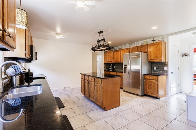 304 Simpson Rd, Irondequoit, NY 14617 - kitchen featuring stainless steel fridge with ice dispenser, a ceiling fan, tasteful backsplash, a kitchen island, and brown cabinetry