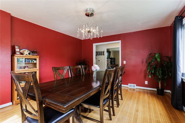 304 Simpson Rd, Irondequoit, NY 14617 - dining area featuring light wood finished floors and a chandelier