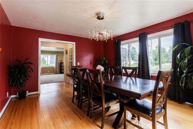 304 Simpson Rd, Irondequoit, NY 14617 - dining room with light wood-style floors and a chandelier
