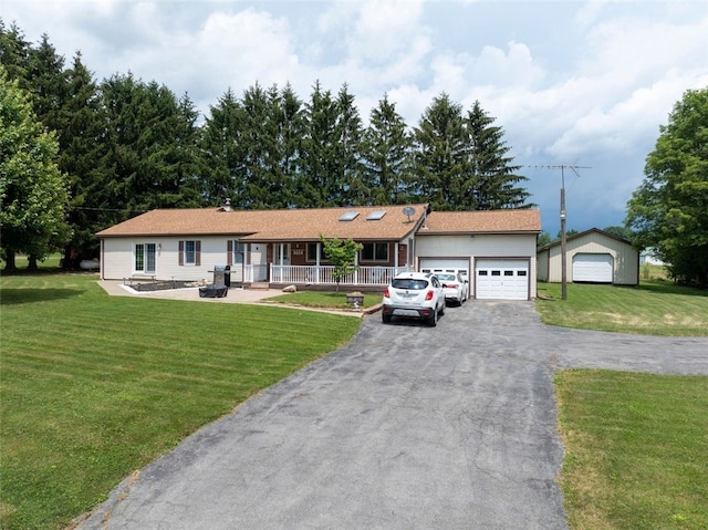 9447 County Route 75, Pulteney, NY 14418 - ranch-style home featuring covered porch, a garage, a front lawn, and asphalt driveway