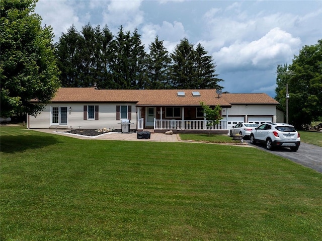 9447 County Route 75, Pulteney, NY 14418 - single story home featuring asphalt driveway, an attached garage, covered porch, and a front yard